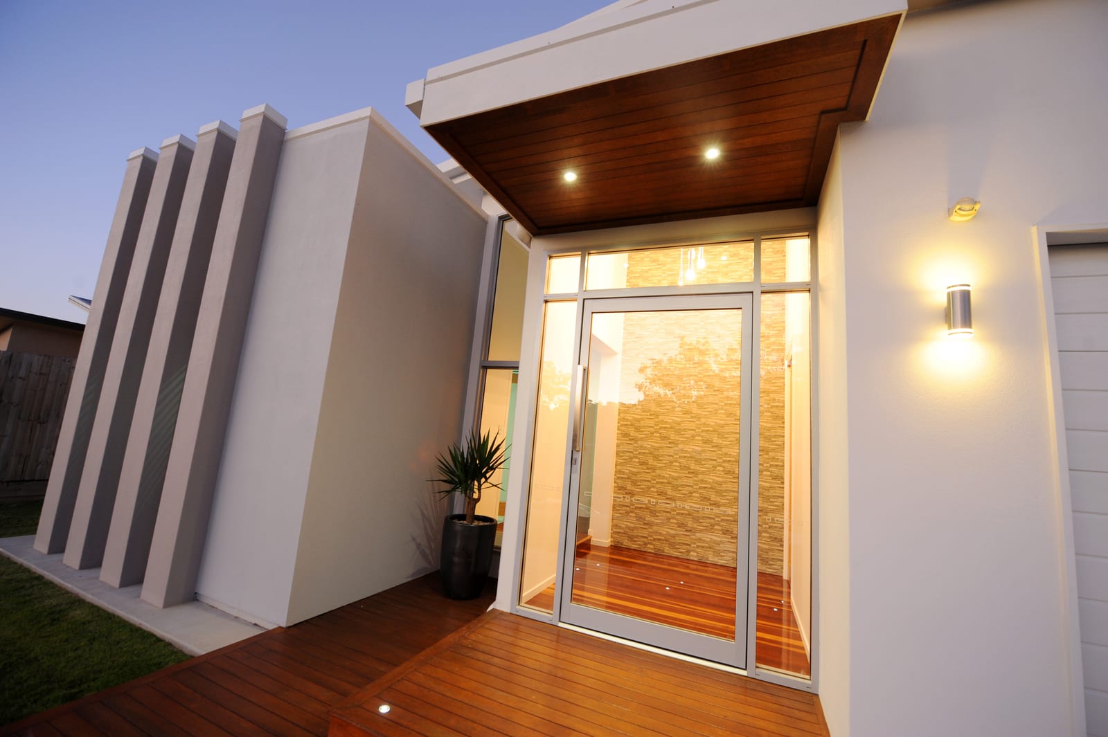 Architectural entry of a custom home at dusk